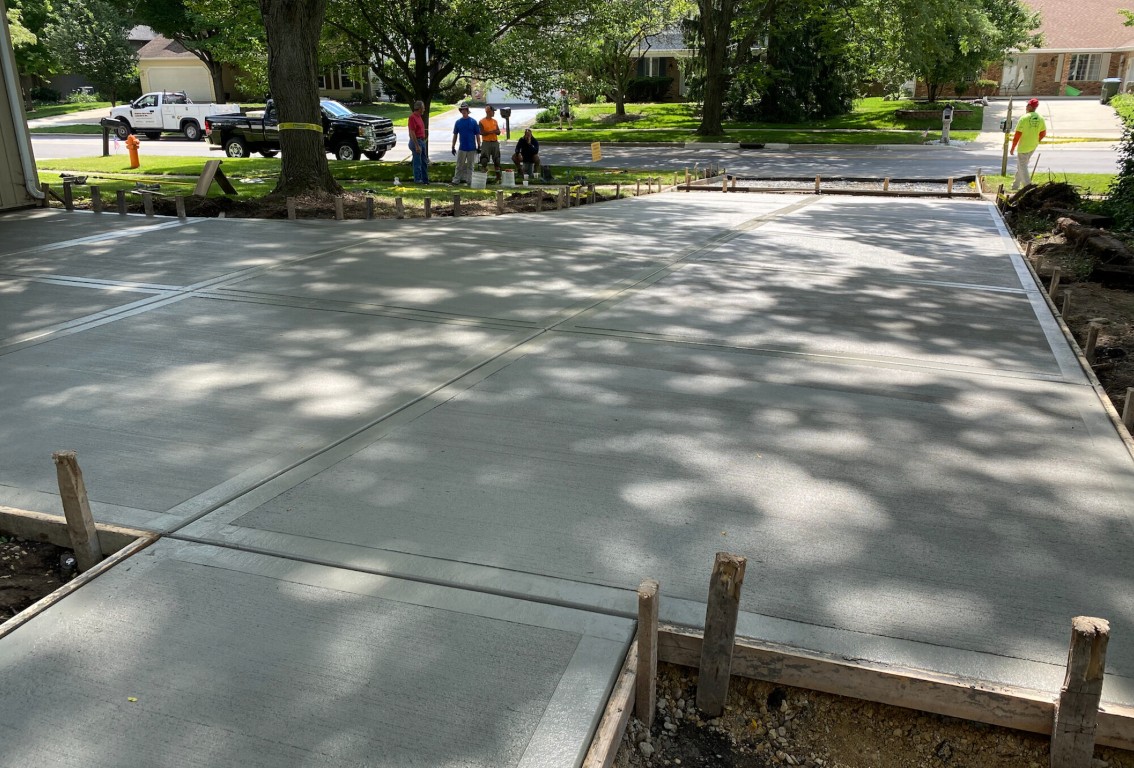 Professional concrete contractors pouring a residential driveway in Hamden, CT