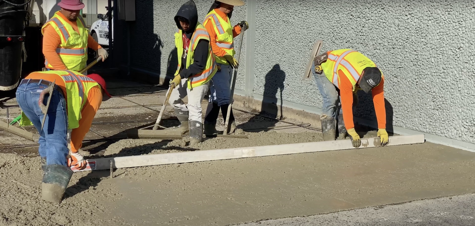 Professional concrete installation team working on commercial project Commercial concrete crew performing professional sidewalk installation