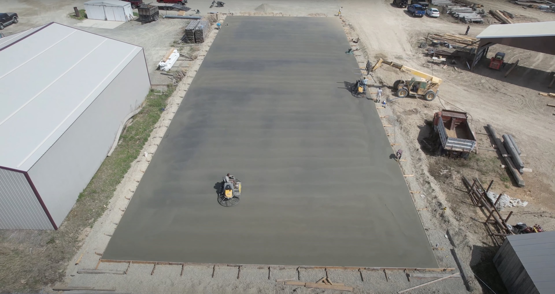 Large-scale commercial concrete slab construction project Aerial view of large commercial concrete slab installation project