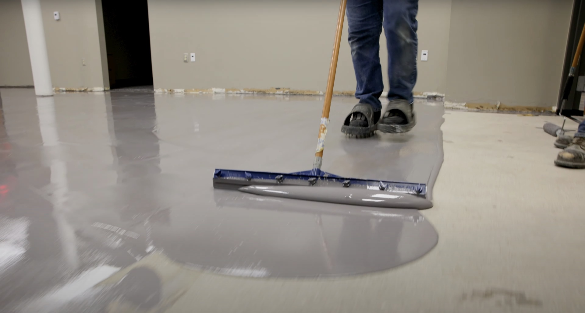 Commercial concrete floor installation and finishing Smooth concrete floor finishing with professional squeegee equipment