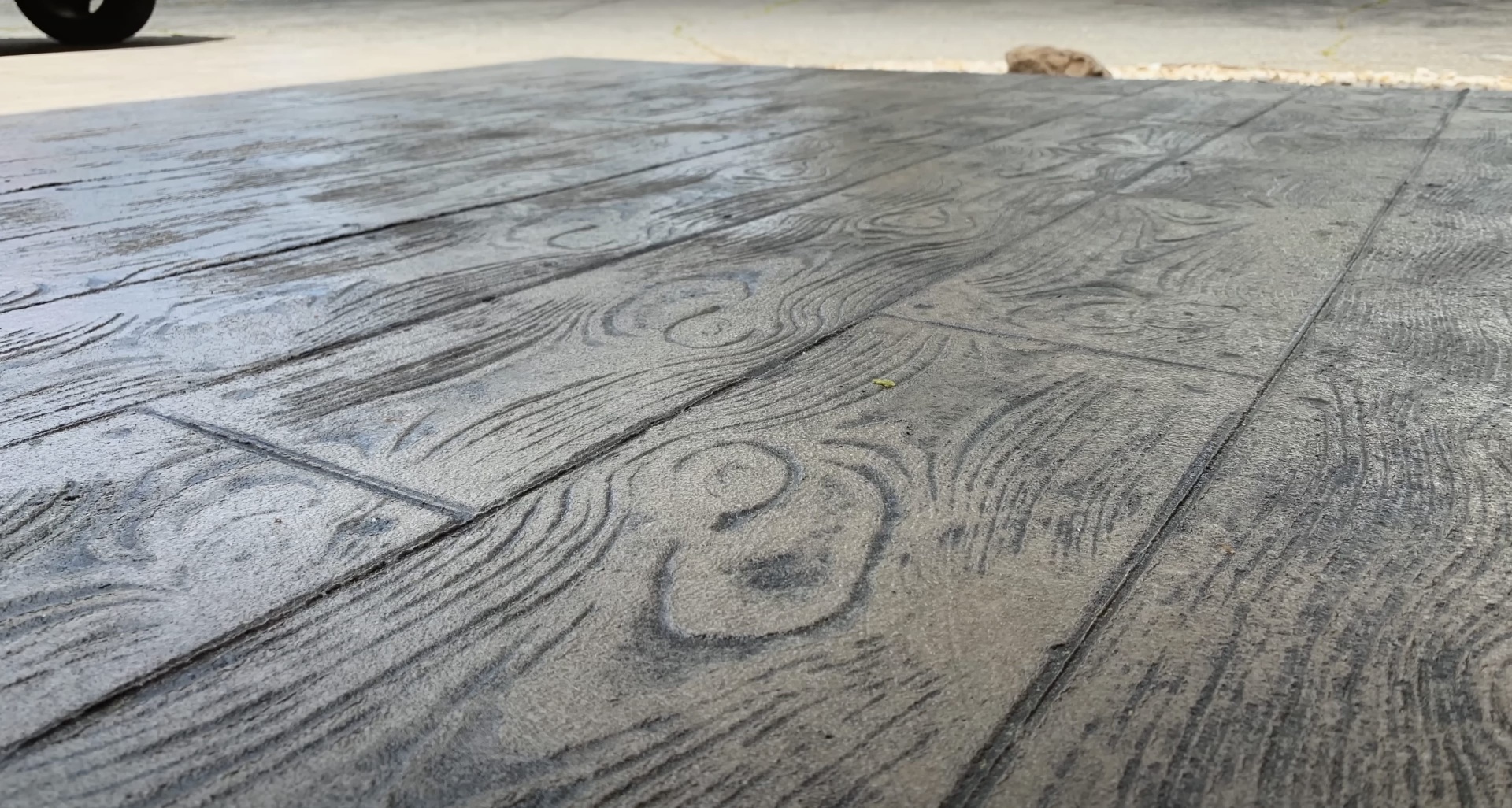 Close-up of professional stamped concrete wood grain finish Detailed view of stamped concrete wood grain texture and pattern work